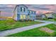Charming two-story home with a two-car garage, lush lawn and blue shutters at 9893 Branching Ship Trce, Wesley Chapel, FL 33545
