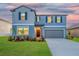 Charming two-story home featuring well-maintained landscaping and a two-car garage at 9893 Branching Ship Trce, Wesley Chapel, FL 33545