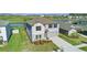 Aerial view of a two story home, featuring landscaping and a two-car garage at 9893 Branching Ship Trce, Wesley Chapel, FL 33545