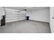 Two car garage with a garage door and ample space for vehicles and storage at 9893 Branching Ship Trce, Wesley Chapel, FL 33545