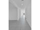 Hallway featuring neutral gray tiles, light-colored walls, and recessed lighting at 9893 Branching Ship Trce, Wesley Chapel, FL 33545
