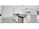 Open-concept kitchen with a large island, stainless steel dishwasher, and abundant natural light, creating a welcoming atmosphere at 9893 Branching Ship Trce, Wesley Chapel, FL 33545