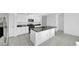 Spacious kitchen featuring a center island, stainless steel appliances, and ample cabinet space, designed for culinary enthusiasts at 9893 Branching Ship Trce, Wesley Chapel, FL 33545