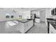 Modern kitchen boasting an island, stainless steel appliances, and views to the living room, perfect for entertaining guests at 9893 Branching Ship Trce, Wesley Chapel, FL 33545