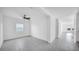 Bright living room featuring neutral tile flooring, white walls, and two large windows at 9893 Branching Ship Trce, Wesley Chapel, FL 33545