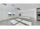 Bright and airy living room with scenic lake views, featuring tile flooring and abundant natural light, perfect for relaxation at 9893 Branching Ship Trce, Wesley Chapel, FL 33545