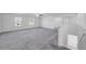 Spacious loft area with carpet, natural light and plenty of space for entertaining at 9893 Branching Ship Trce, Wesley Chapel, FL 33545