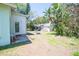 View of the home's backyard with lush landscaping and mature trees at 10321 Ravines Dr, New Port Richey, FL 34654