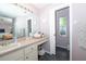 Bathroom featuring a vanity with a sink, large mirror, and access to a toilet at 10321 Ravines Dr, New Port Richey, FL 34654
