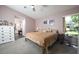 Comfortable bedroom with neutral tones, a ceiling fan, and access to an ensuite bathroom at 10321 Ravines Dr, New Port Richey, FL 34654