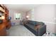 Relaxing bedroom with a gray couch, ample natural light, and a cozy atmosphere at 10321 Ravines Dr, New Port Richey, FL 34654