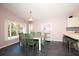 Bright dining room with ample natural light, space for six chairs, and stylish decor provides a great eating area at 10321 Ravines Dr, New Port Richey, FL 34654
