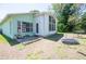 Back exterior view of house with big windows and a small trampoline on the yard at 10321 Ravines Dr, New Port Richey, FL 34654