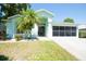 Charming single-story home with a well-maintained lawn and palm tree at 10321 Ravines Dr, New Port Richey, FL 34654