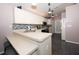 Spacious kitchen with modern appliances, white cabinetry, breakfast bar, and black tile flooring at 10321 Ravines Dr, New Port Richey, FL 34654