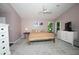 Serene bedroom featuring neutral walls, a ceiling fan, and abundant natural light from the backyard at 10321 Ravines Dr, New Port Richey, FL 34654