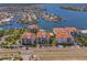 Beautiful aerial shot of waterfront condos with stunning views, a swimming pool, and meticulously kept landscaping at 1042 Bellasol Way # 202, Apollo Beach, FL 33572