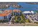 Expansive aerial shot capturing the building, community pond, and extensive parking area at 1042 Bellasol Way # 202, Apollo Beach, FL 33572