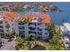 Stunning aerial view showcasing the building's proximity to the water and surrounding community at 1042 Bellasol Way # 202, Apollo Beach, FL 33572
