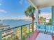 This balcony features bright blue seating with a stunning waterfront view at 1042 Bellasol Way # 202, Apollo Beach, FL 33572