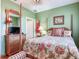 Bedroom featuring a four poster bed, dresser with TV, and stylish decor at 1042 Bellasol Way # 202, Apollo Beach, FL 33572