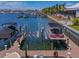 Boat lift in the water with boats docked and marina in the background at 1042 Bellasol Way # 202, Apollo Beach, FL 33572