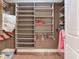 This walk-in closet has built-in shelves and hanging rods at 1042 Bellasol Way # 202, Apollo Beach, FL 33572