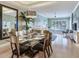 Formal dining area flows into a living room with large windows offering plenty of natural light at 1042 Bellasol Way # 202, Apollo Beach, FL 33572