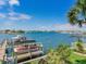 Wide angle landscape featuring a dock with multiple boats parked in slips under clear skies at 1042 Bellasol Way # 202, Apollo Beach, FL 33572