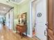 Inviting hallway with wood floors, decorative lamps, and view of a bathroom at 1042 Bellasol Way # 202, Apollo Beach, FL 33572
