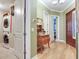 Hallway featuring a stacked washer and dryer, and hardwood floors at 1042 Bellasol Way # 202, Apollo Beach, FL 33572