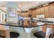 Kitchen with granite countertops, stainless appliances, breakfast bar, and light wood cabinetry throughout at 1042 Bellasol Way # 202, Apollo Beach, FL 33572