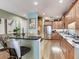 Bright kitchen featuring stainless steel appliances, bar seating, light wood cabinetry and light-toned granite countertops at 1042 Bellasol Way # 202, Apollo Beach, FL 33572