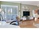 Living area with a zebra print chair, modern decor, and water views through shuttered windows at 1042 Bellasol Way # 202, Apollo Beach, FL 33572