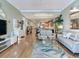 Spacious living area with wood floors, light colors and decor, with open access to the kitchen at 1042 Bellasol Way # 202, Apollo Beach, FL 33572