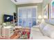 Bright home office space featuring a modern desk, comfortable seating, and plantation shutters at 1042 Bellasol Way # 202, Apollo Beach, FL 33572