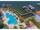 Aerial view of community pool, boat docks, palm trees and waterfront at 1042 Bellasol Way # 202, Apollo Beach, FL 33572