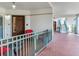 Inviting porch with outdoor seating, red cushions, and tiled flooring at 1042 Bellasol Way # 202, Apollo Beach, FL 33572