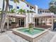 Inviting water fountain framed by covered community areas with tables and chairs at 1042 Bellasol Way # 202, Apollo Beach, FL 33572