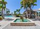 Beautiful water fountain, palm trees, and tiki bar create a serene community gathering space at 1042 Bellasol Way # 202, Apollo Beach, FL 33572