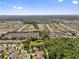 Panoramic aerial view of a residential neighborhood and the surrounding landscape featuring the home with solar panels at 10514 Scenic Hollow Dr, Riverview, FL 33578