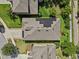 Birds-eye view featuring solar panels on the roof and a brick-lined driveway of a home with neat landscaping at 10514 Scenic Hollow Dr, Riverview, FL 33578