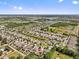 Expansive aerial view featuring a residential neighborhood, highlighting the home amidst tranquil ponds and lush landscape at 10514 Scenic Hollow Dr, Riverview, FL 33578