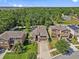 Aerial shot showcasing the home's roof with solar panels and landscaped yard in a lush, green neighborhood at 10514 Scenic Hollow Dr, Riverview, FL 33578