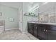 Bathroom with a granite double sink vanity with decor and tile floors at 10514 Scenic Hollow Dr, Riverview, FL 33578