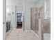 Bathroom with glass shower and granite double sink vanity that leads to the bedroom at 10514 Scenic Hollow Dr, Riverview, FL 33578