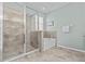 Bathroom with a large glass shower and a soaking tub tiled with decorative tile at 10514 Scenic Hollow Dr, Riverview, FL 33578