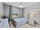 Serene bedroom with a crystal chandelier, gray walls, and plush bedding, offering a tranquil retreat at 10514 Scenic Hollow Dr, Riverview, FL 33578