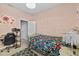 Bedroom featuring stylish decor, a bed with floral bedding and a desk at 10514 Scenic Hollow Dr, Riverview, FL 33578