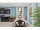 Bright dining room with large windows, decorative chandelier, and wooden dining set, perfect for Gathering gatherings at 10514 Scenic Hollow Dr, Riverview, FL 33578